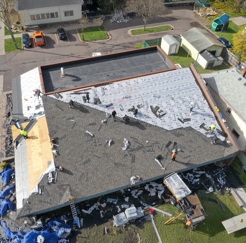 men working on a half finished residential roof