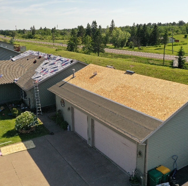 roof of house partially covered in shingles