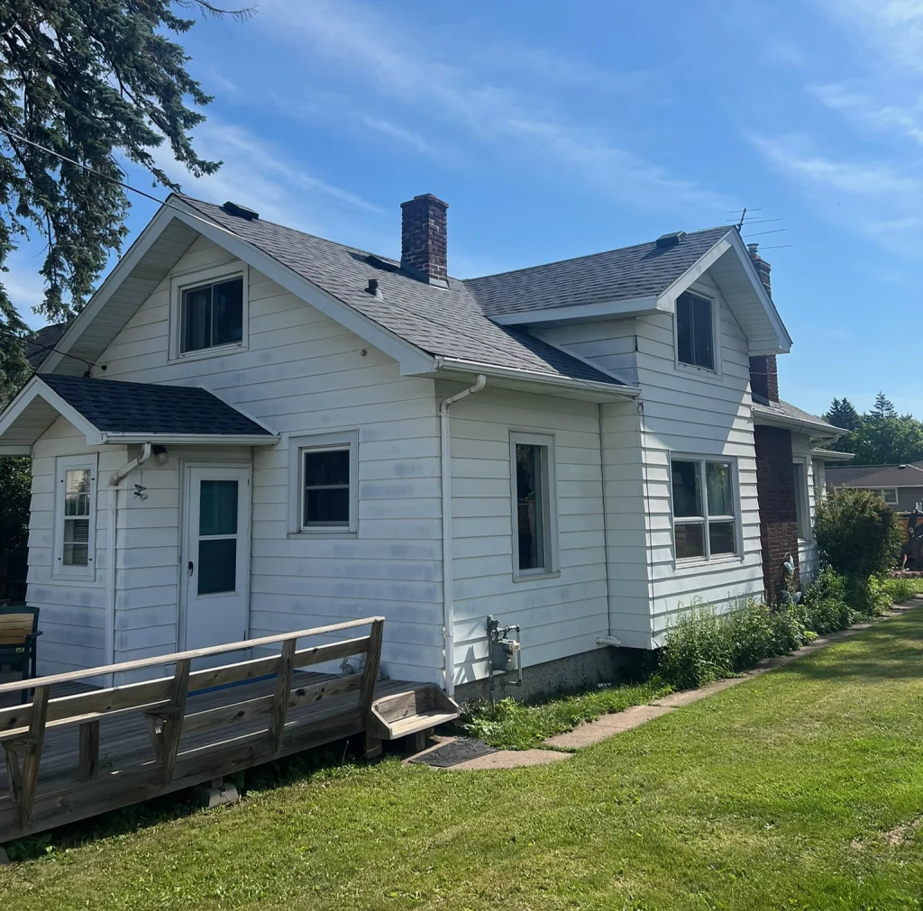 White house with a gray roof and gutters